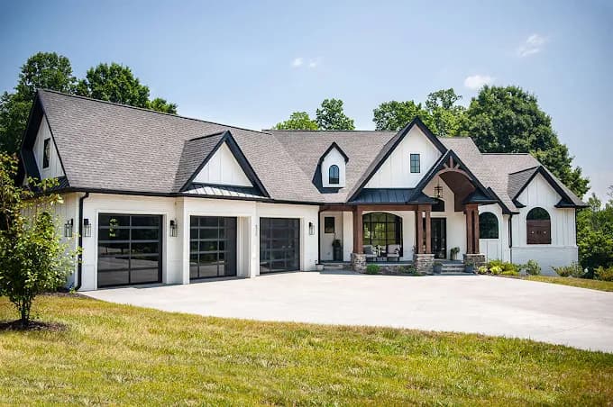 High-end custom home with a professionally installed dark asphalt shingle roof
