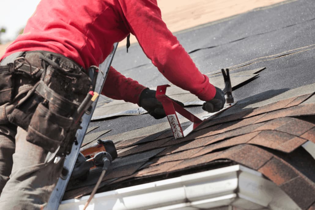 Home mid-repair with a tear-off debris container staged in the driveway